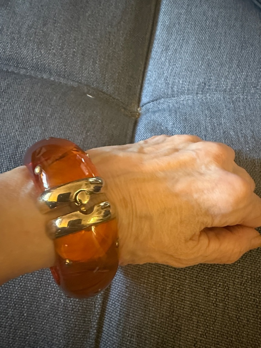 Hinged Studded Resin Bangle Bracelet Featuring a Translucent Amber Color.